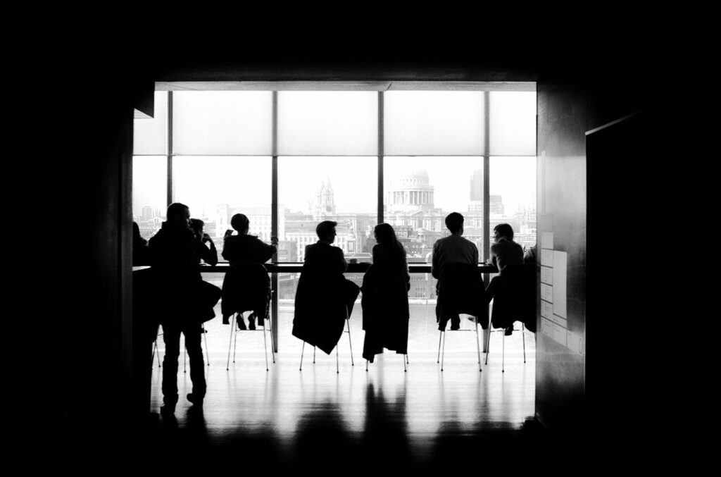 Silhouettes of people in a meeting room on modern office with views of St Pauls